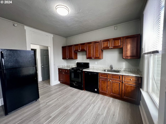 401 NW Bailey Ave, Pendleton, OR 97801 - kitchen featuring black appliances, a sink, light wood-style floors, baseboards, and light stone countertops