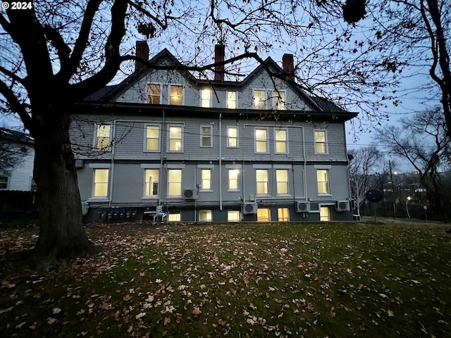 back of house with a lawn