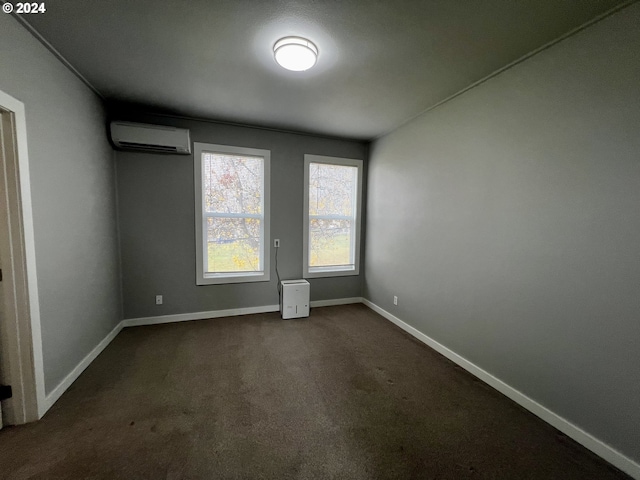 carpeted spare room with an AC wall unit