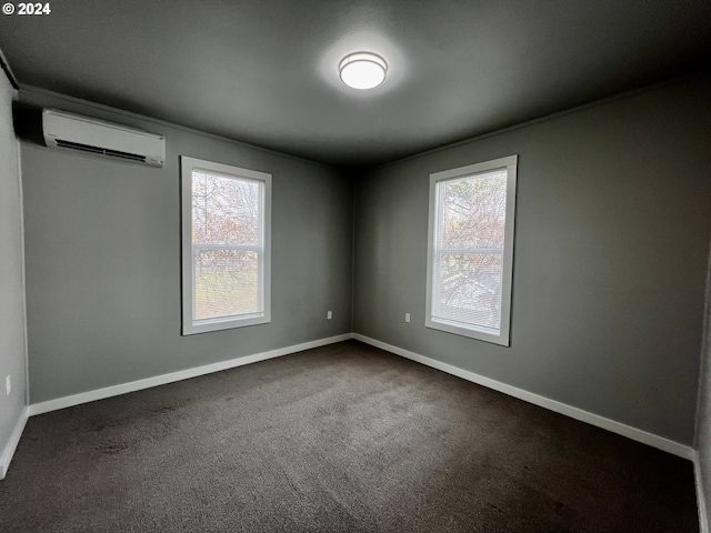 carpeted empty room with an AC wall unit