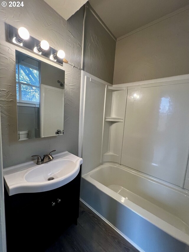 full bathroom featuring shower / bath combination, vanity, wood-type flooring, and toilet