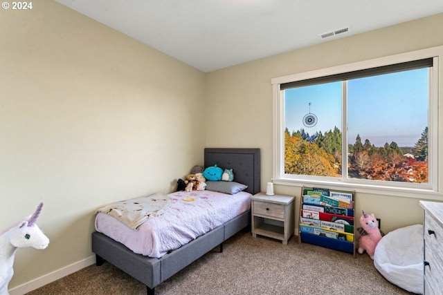 bedroom with carpet and multiple windows