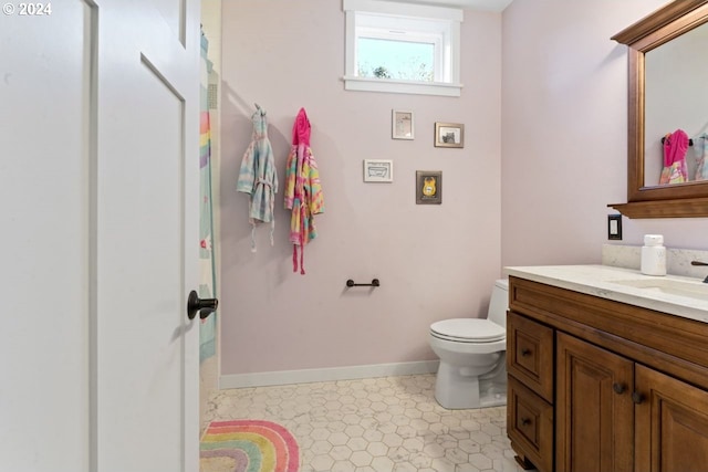 bathroom featuring toilet and vanity