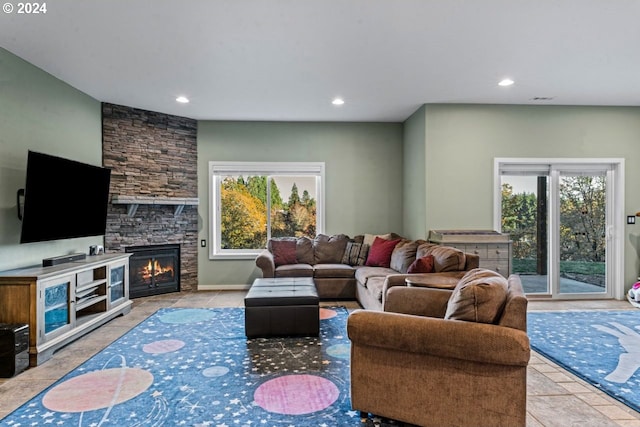 living room with light tile patterned floors and a fireplace