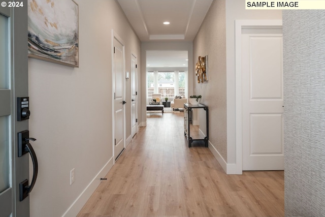 hallway with light hardwood / wood-style floors