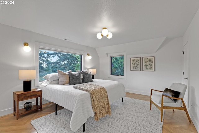 bedroom with light parquet floors