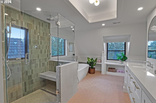 bathroom featuring vanity, separate shower and tub, and plenty of natural light