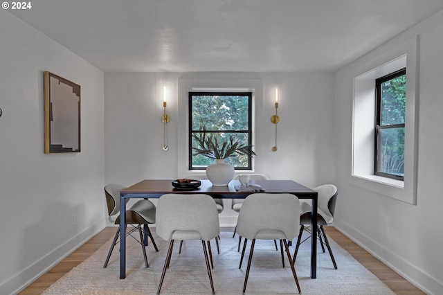 dining space with light hardwood / wood-style floors