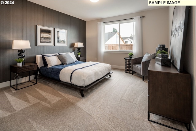 bedroom featuring light colored carpet