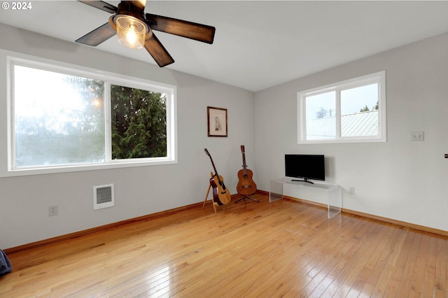 unfurnished living room with light wood-type flooring and ceiling fan