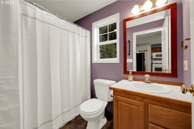 bathroom featuring tile patterned floors, vanity, and toilet