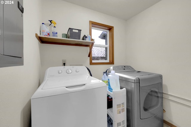 clothes washing area with independent washer and dryer and electric panel