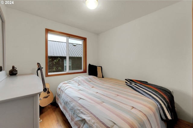 bedroom with hardwood / wood-style flooring