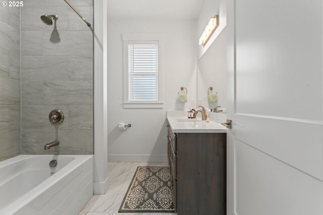 bathroom featuring vanity and tiled shower / bath combo