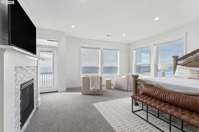 carpeted bedroom featuring access to exterior and a fireplace