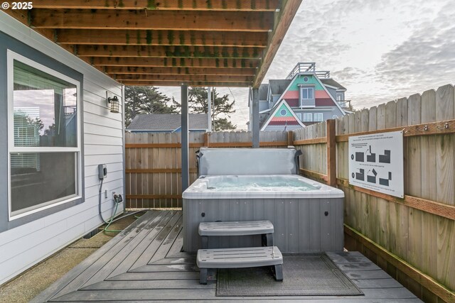 wooden terrace with a hot tub