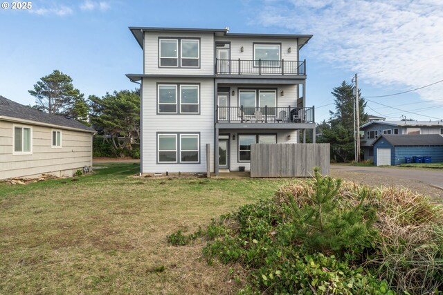 back of property featuring a lawn and a balcony