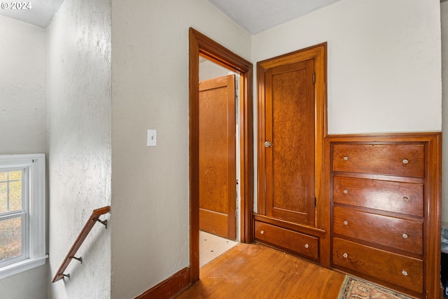 hallway with light hardwood / wood-style flooring