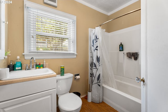 full bathroom with a textured ceiling, vanity, shower / tub combo with curtain, toilet, and hardwood / wood-style flooring