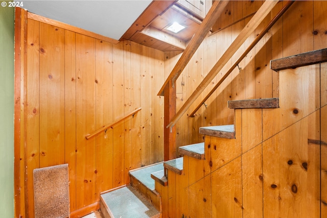 stairs with wood walls and a sauna