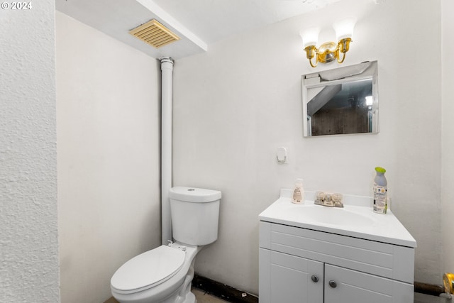 bathroom featuring toilet, visible vents, and vanity