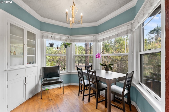 sunroom featuring an inviting chandelier