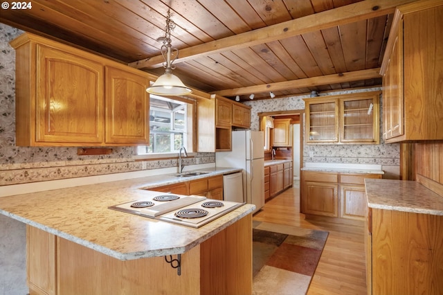 kitchen with white electric cooktop, pendant lighting, sink, light hardwood / wood-style floors, and beam ceiling