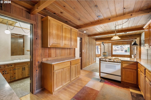 kitchen featuring hanging light fixtures, sink, white range, and light wood-type flooring