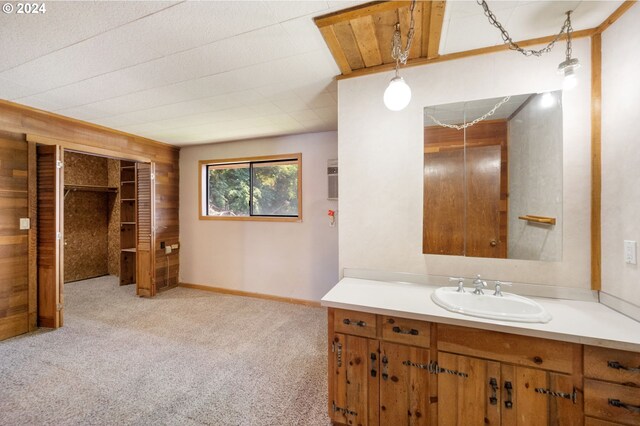 bathroom featuring wood walls and vanity