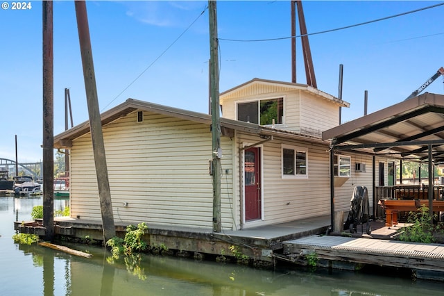 rear view of house featuring a water view