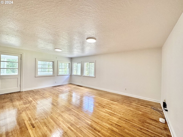 empty room with light hardwood / wood-style flooring