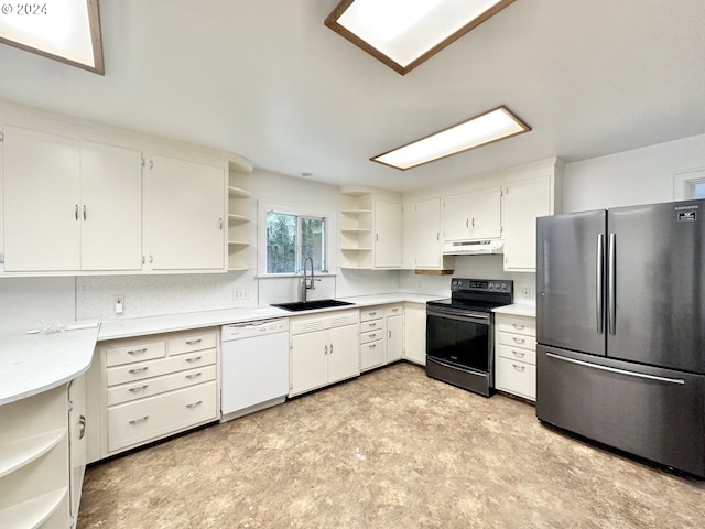 kitchen with white dishwasher, sink, white cabinets, stainless steel refrigerator, and black / electric stove