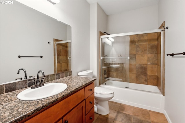 full bathroom with enclosed tub / shower combo, vanity, and toilet