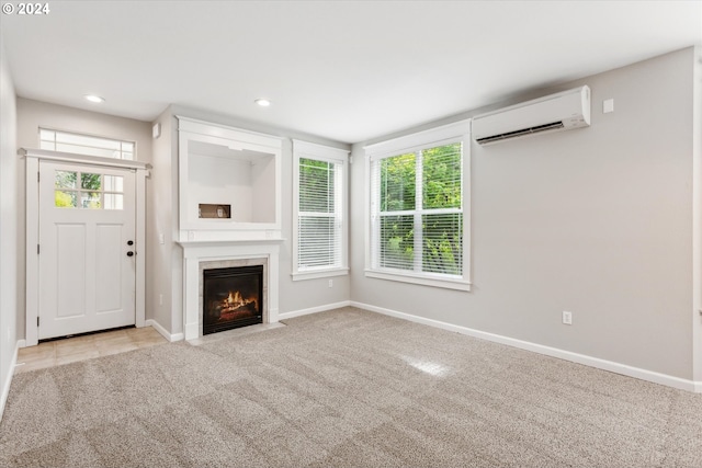 unfurnished living room with light carpet, a wall mounted AC, and a premium fireplace