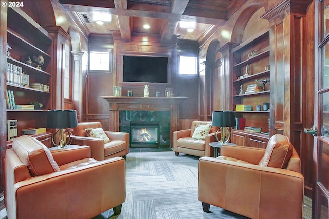 sitting room featuring built in shelves, coffered ceiling, a premium fireplace, and plenty of natural light