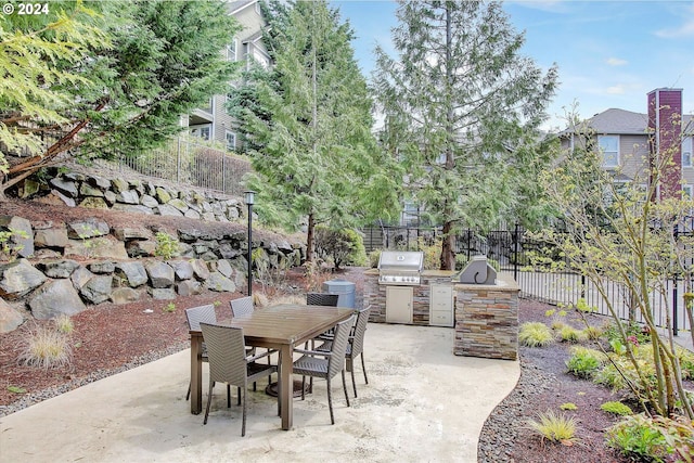 view of patio featuring an outdoor kitchen and a grill