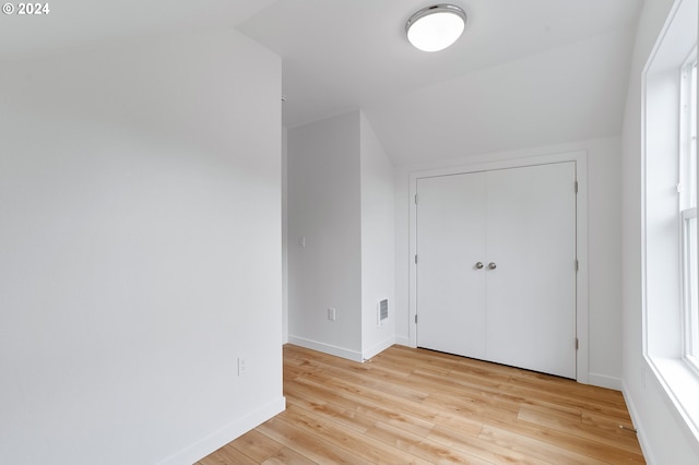 bonus room featuring light hardwood / wood-style flooring and lofted ceiling