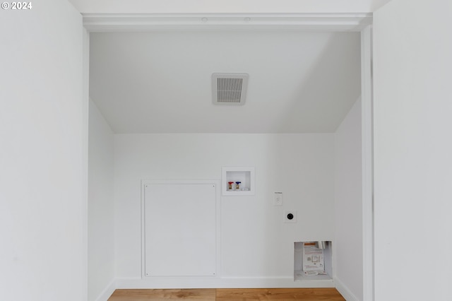 unfurnished bedroom featuring light hardwood / wood-style floors, a closet, and vaulted ceiling