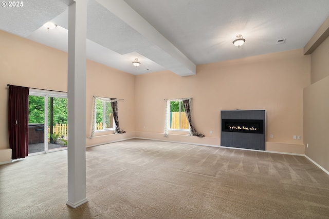 17413 Wake Robin Cir, Oregon City, OR 97045 - unfurnished living room with carpet, a lit fireplace, and baseboards