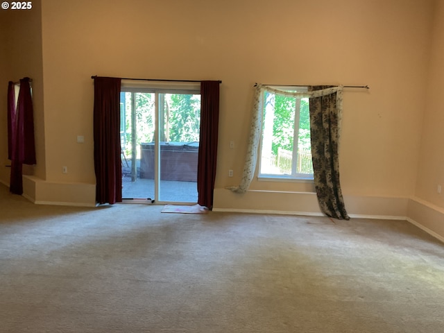carpeted spare room with baseboards