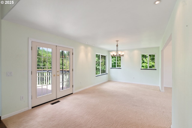 17413 Wake Robin Cir, Oregon City, OR 97045 - spare room with french doors, light colored carpet, a chandelier, baseboards, and recessed lighting