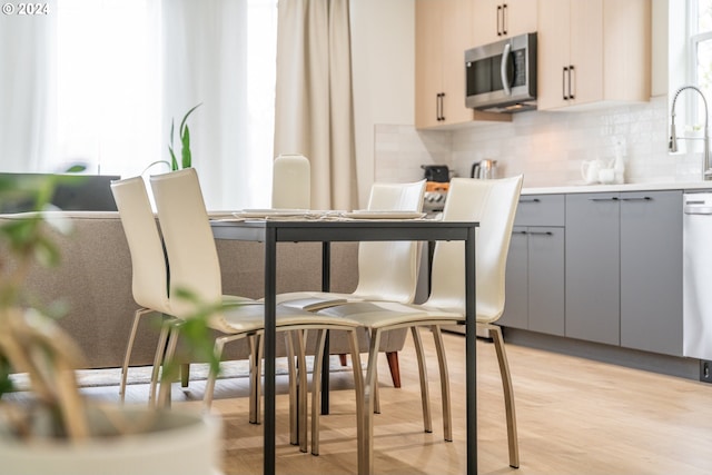 dining space with light hardwood / wood-style floors