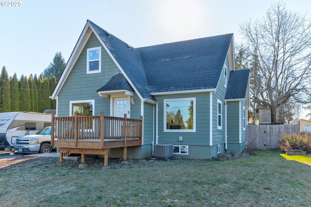 view of front of home with a wooden deck, central AC, a front yard, and a carport