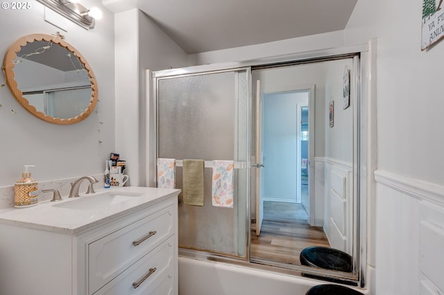 bathroom featuring vanity and combined bath / shower with glass door