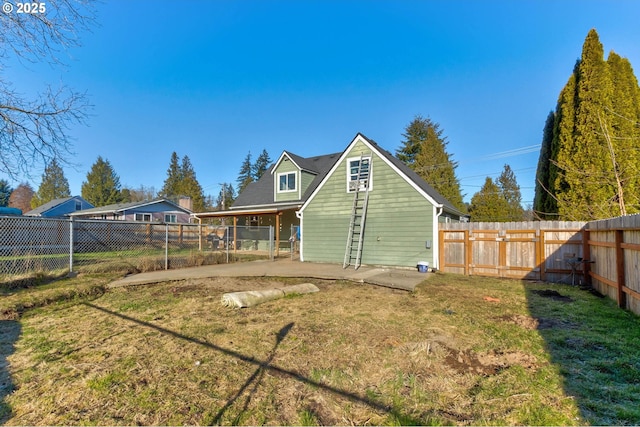 rear view of property with a yard