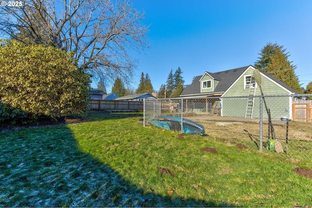 view of yard with a fenced in pool