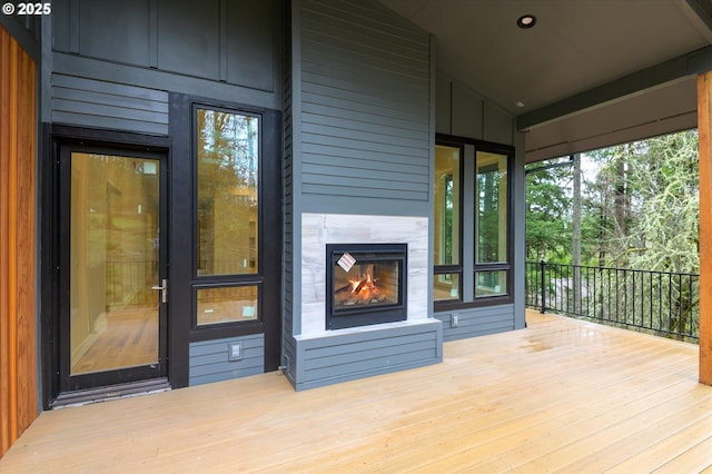 wooden terrace featuring a tile fireplace