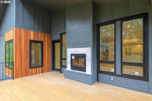 wooden terrace featuring a tiled fireplace