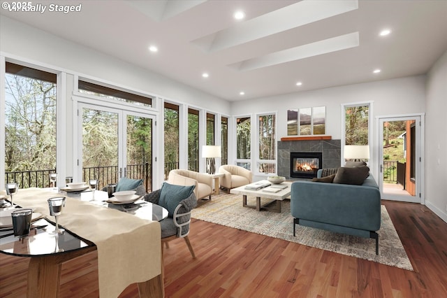 living room featuring wood-type flooring and a fireplace