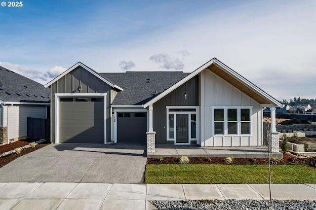 view of front of home featuring board and batten siding, concrete driveway, roof with shingles, and an attached garage